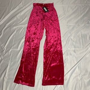 Hot pink velvet pants with belt.